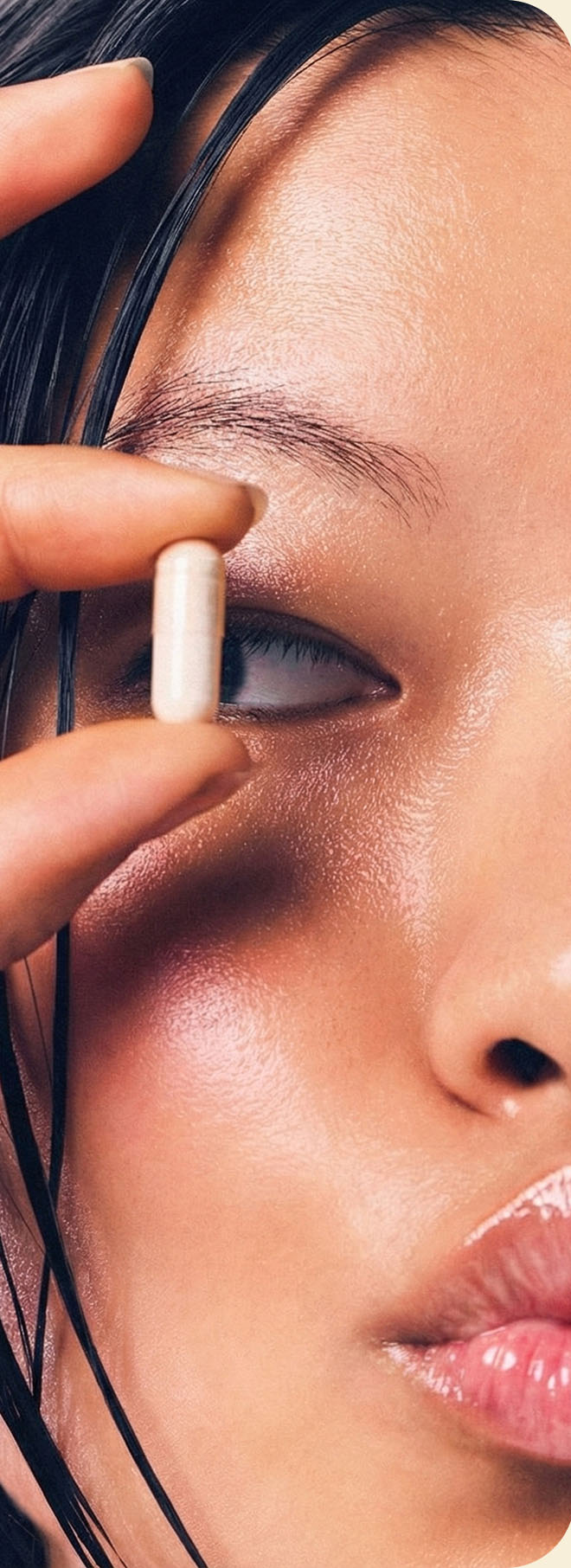 Close-up portrait holding a Focus Formula capsule